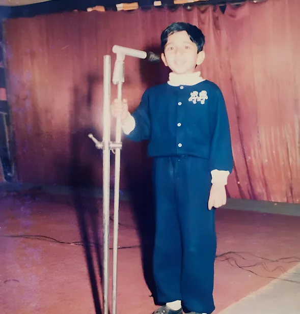 Young Sandeep singing on stage